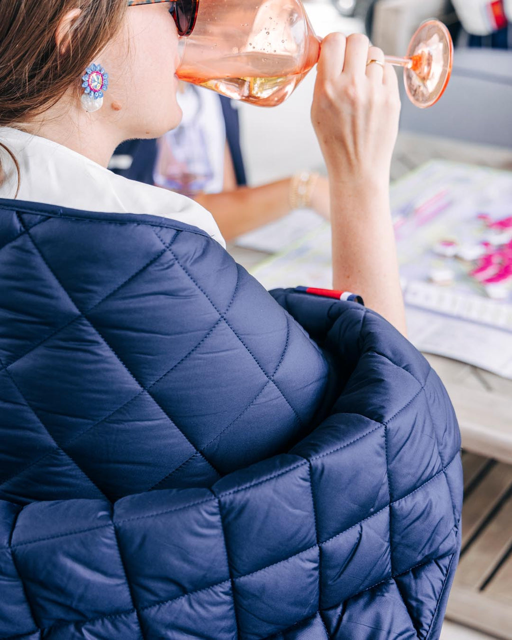 Waterproof puffer blanket with pockets, navy quilted fabric close-up