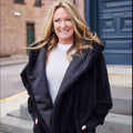 Black waterproof hooded cardigan with zip front and soft plush texture