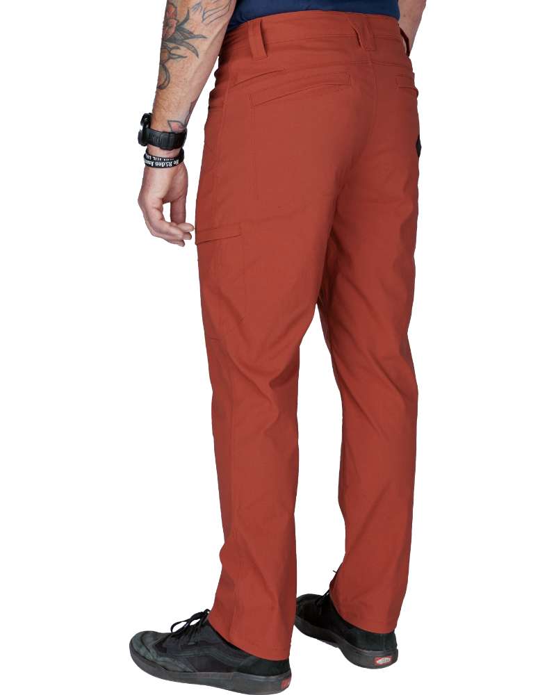 Rust red tapered pants with back pocket stitching and clean ankle opening