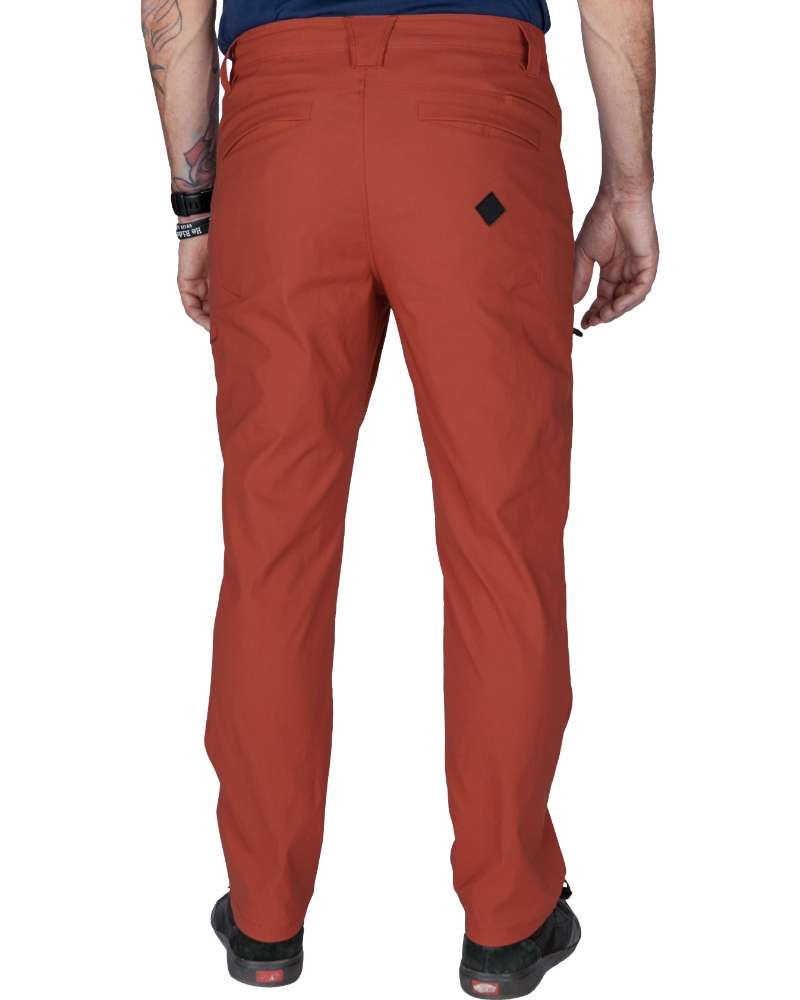 Rust red tapered pants from back with belt loops and small logo patch