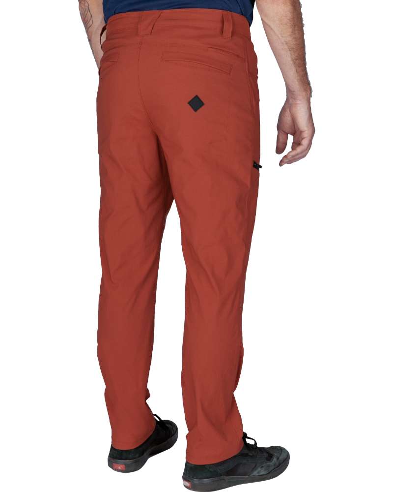 Rust red tapered pants from rear view with back pocket seams