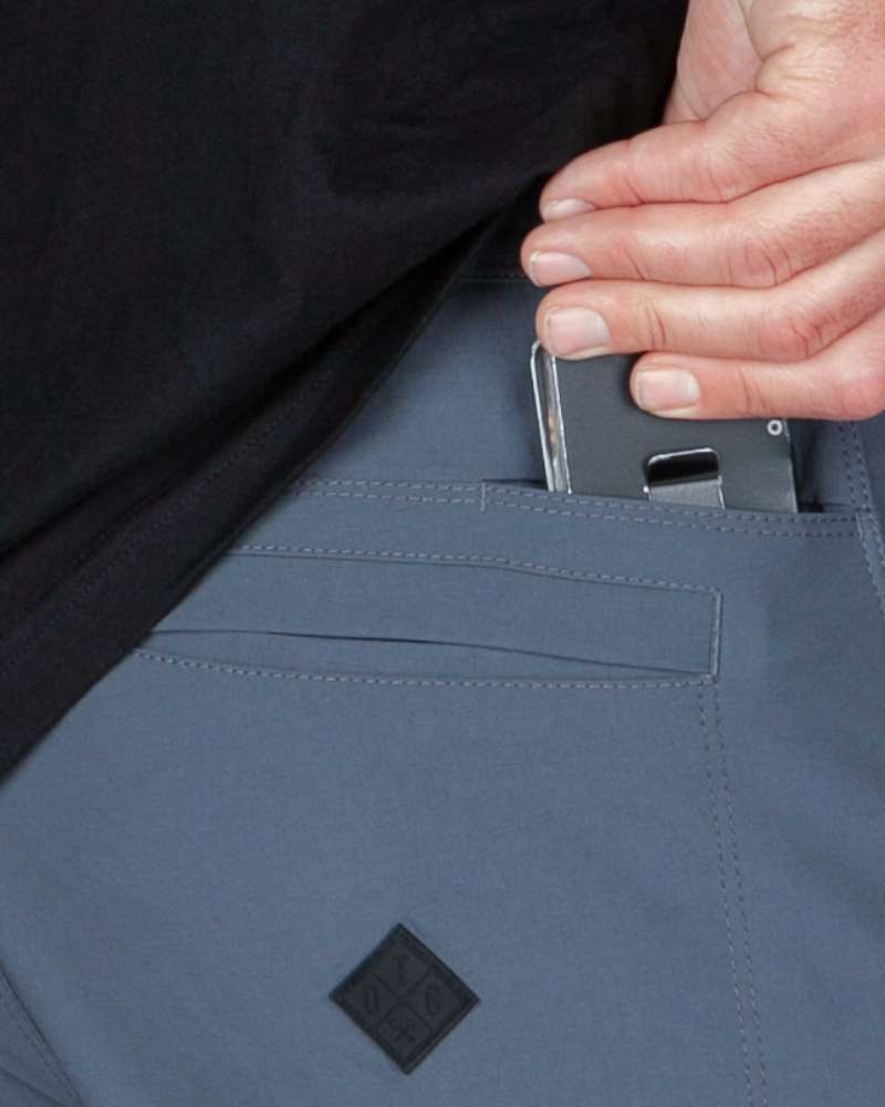 Gray-blue pant pocket with concealed phone slot and small black patch logo