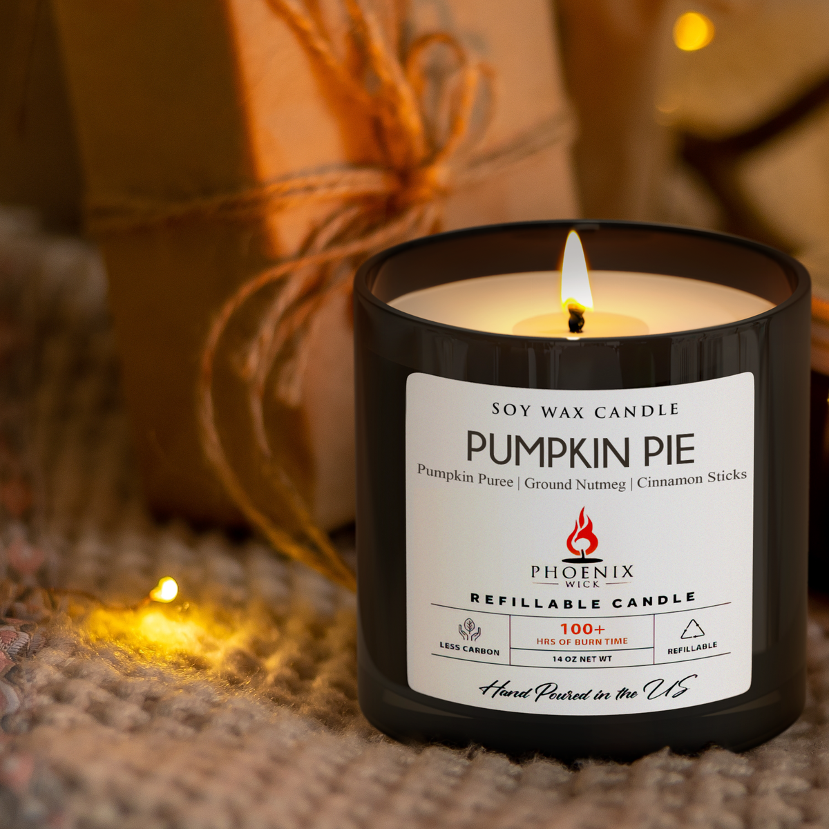 Pumpkin pie filled candle in black glass jar with lit flame and product label