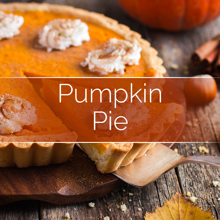 Pumpkin pie slices with whipped cream topping on rustic wooden surface