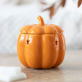 Orange ceramic pumpkin wax melt burner with domed lid and curved spout