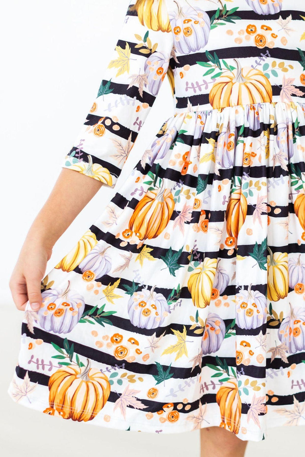 Girls' pumpkin print dress with ruffle trim and tiered skirt hem detail