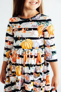 Girls' pumpkin print twirl dress with 3/4 sleeves and striped tiered skirt