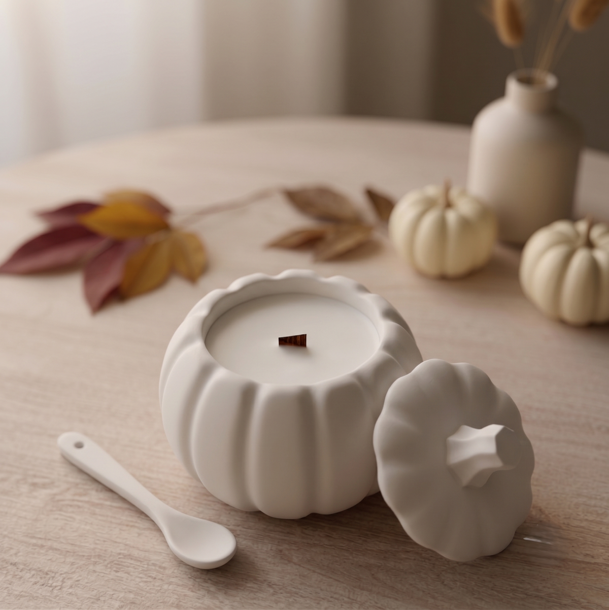 White pumpkin candle viewed from above with small matching lid and spoon
