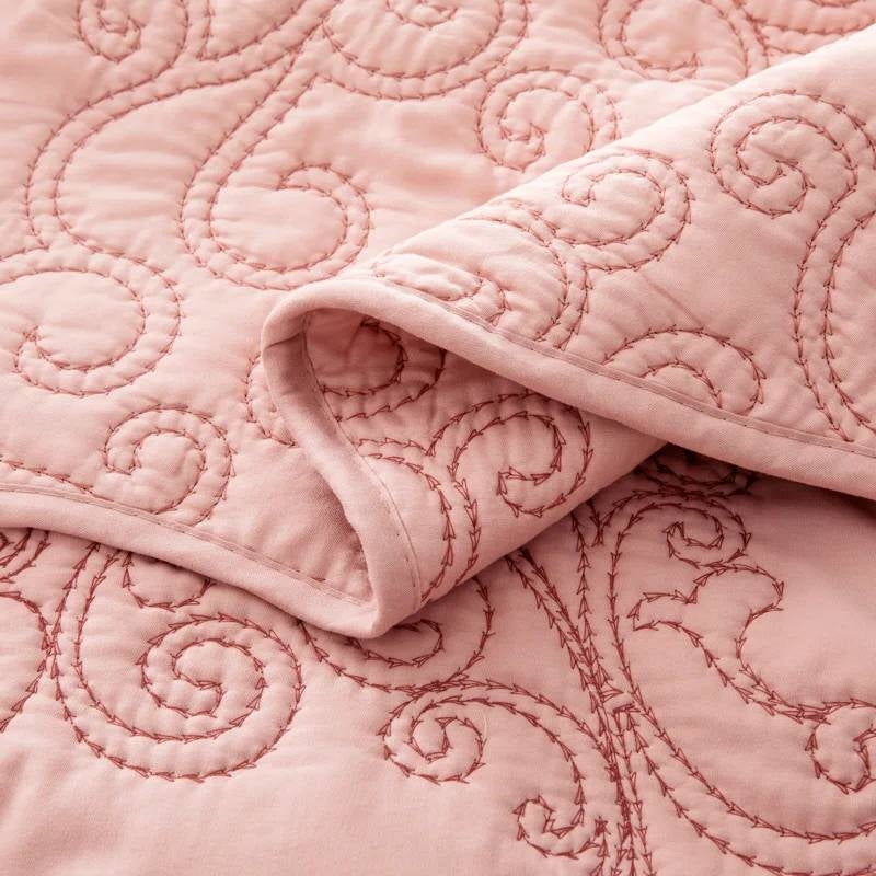Dusty pink damask embroidered quilted fabric with stitched swirl pattern