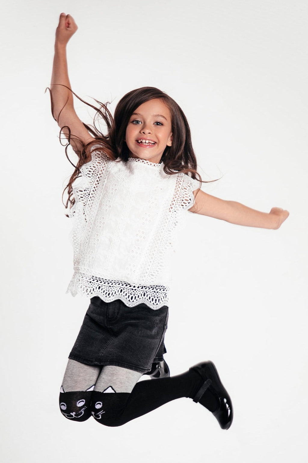 Kids' cotton tights in black with cat-face designs on the lower legs