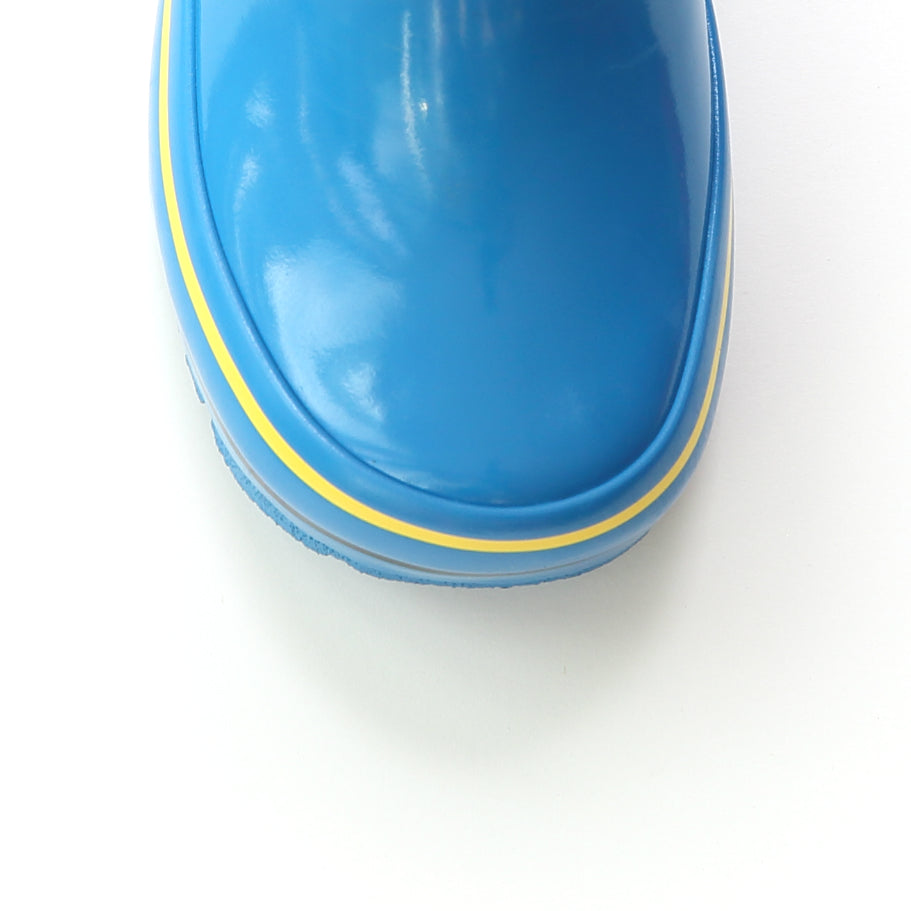 Blue rain boot close-up with yellow welt and rugged tread sole