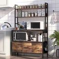 Black metal baker's rack with brown wood shelves and cabinet storage, open frame