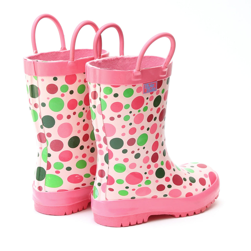 Pink rain boots with multicolor dot print, pull-on handles, and tread sole