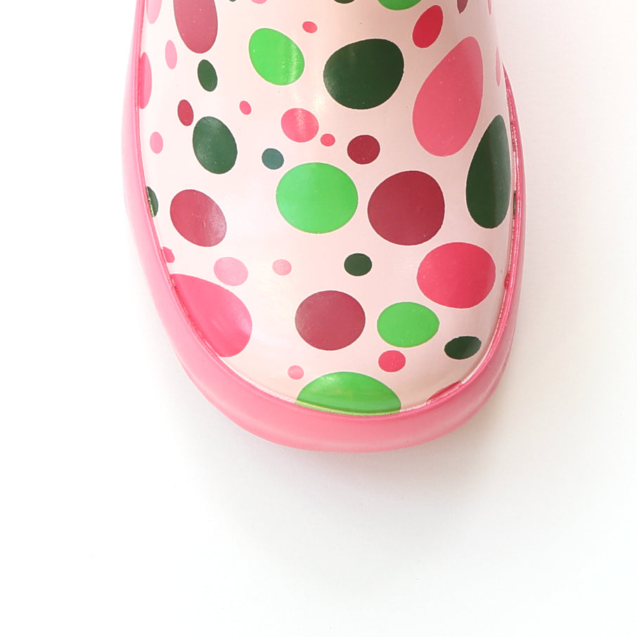 Pink rain boot toe with multicolor dot pattern and molded rubber edge