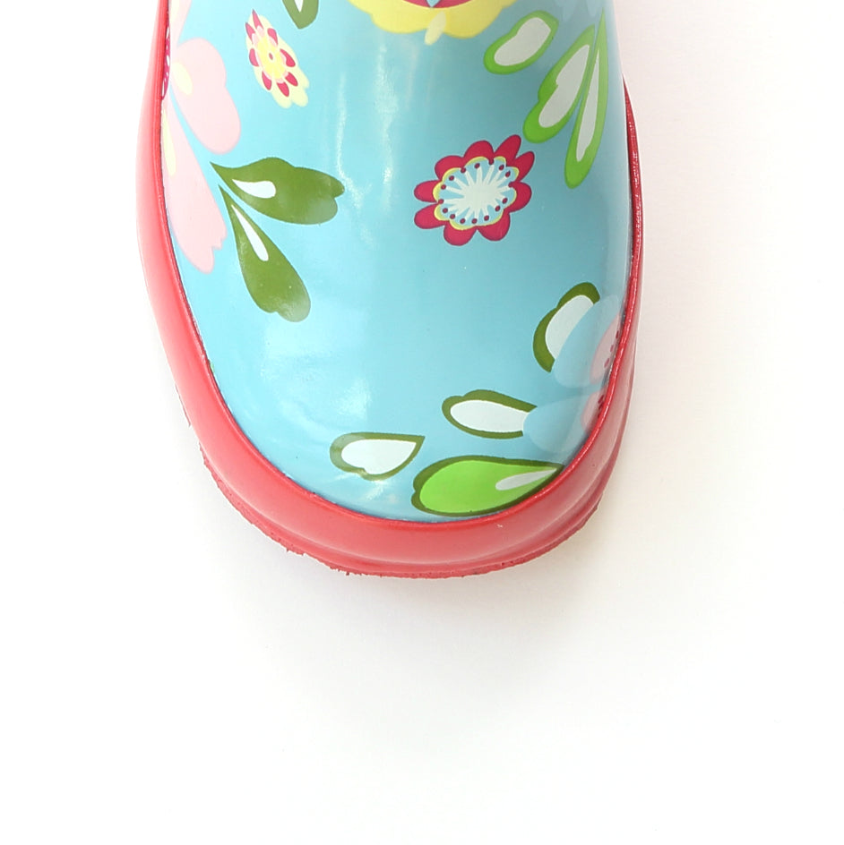 Teal floral rain boot side view with red rubber sole and trim