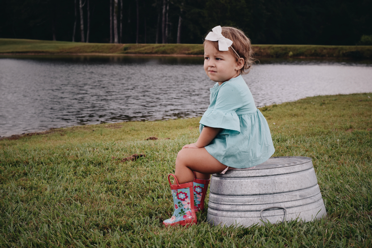 Teal floral rain boots with red trim and floral side panels