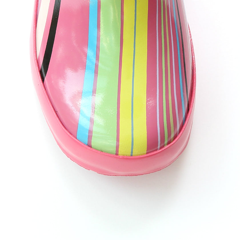 Glossy pink rain boot close-up with rainbow vertical stripes and pink sole edge
