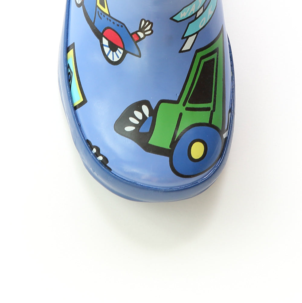 Blue rain boot toe with green truck graphic and patterned rubber sole edge