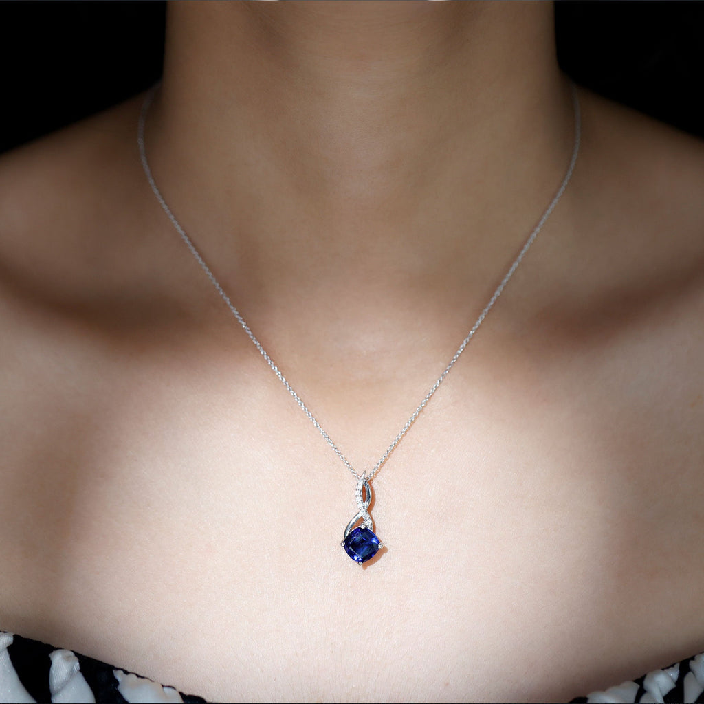 Blue sapphire infinity pendant necklace with silver-tone chain
