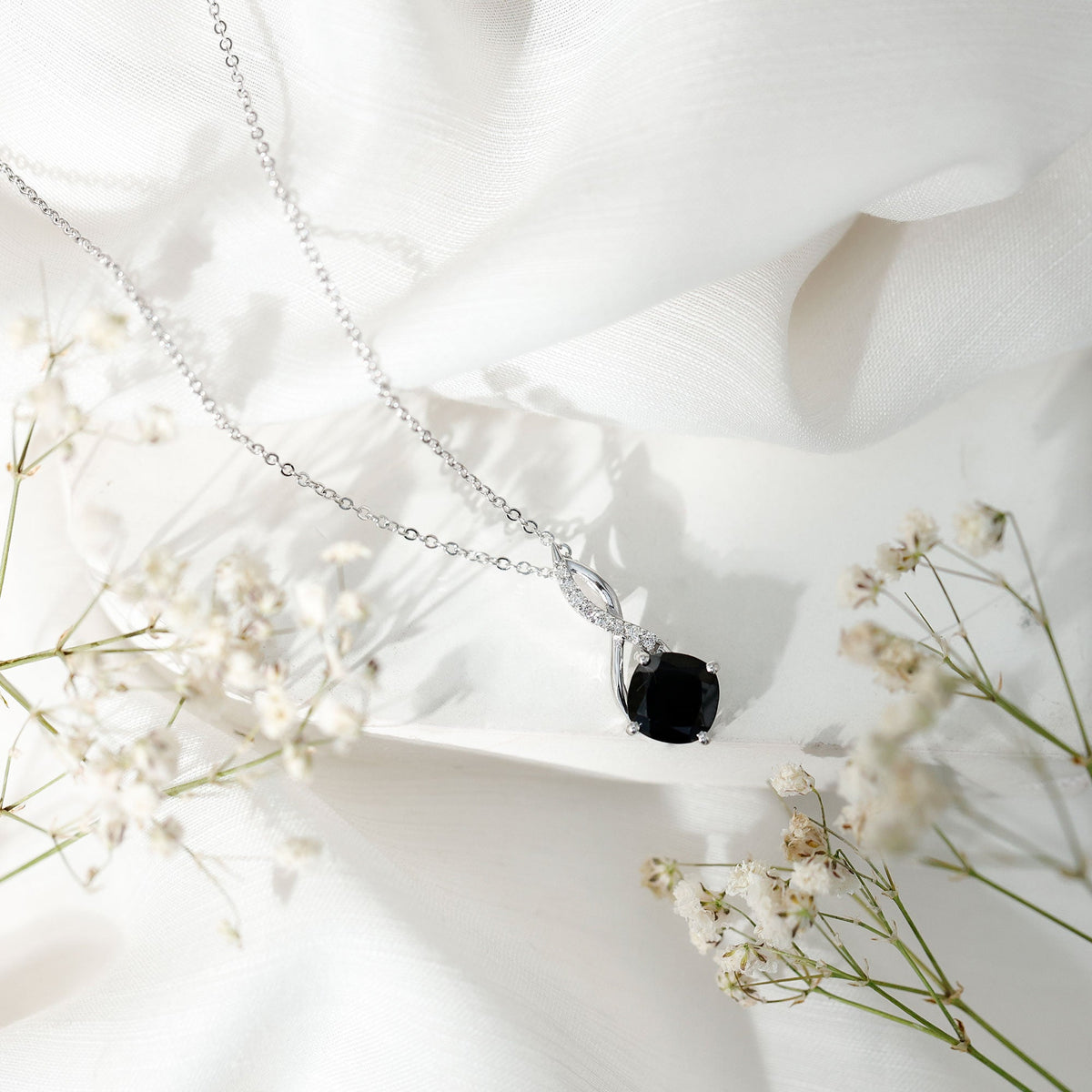 Infinity necklace with cushion-cut black diamond pendant on a silver-tone chain