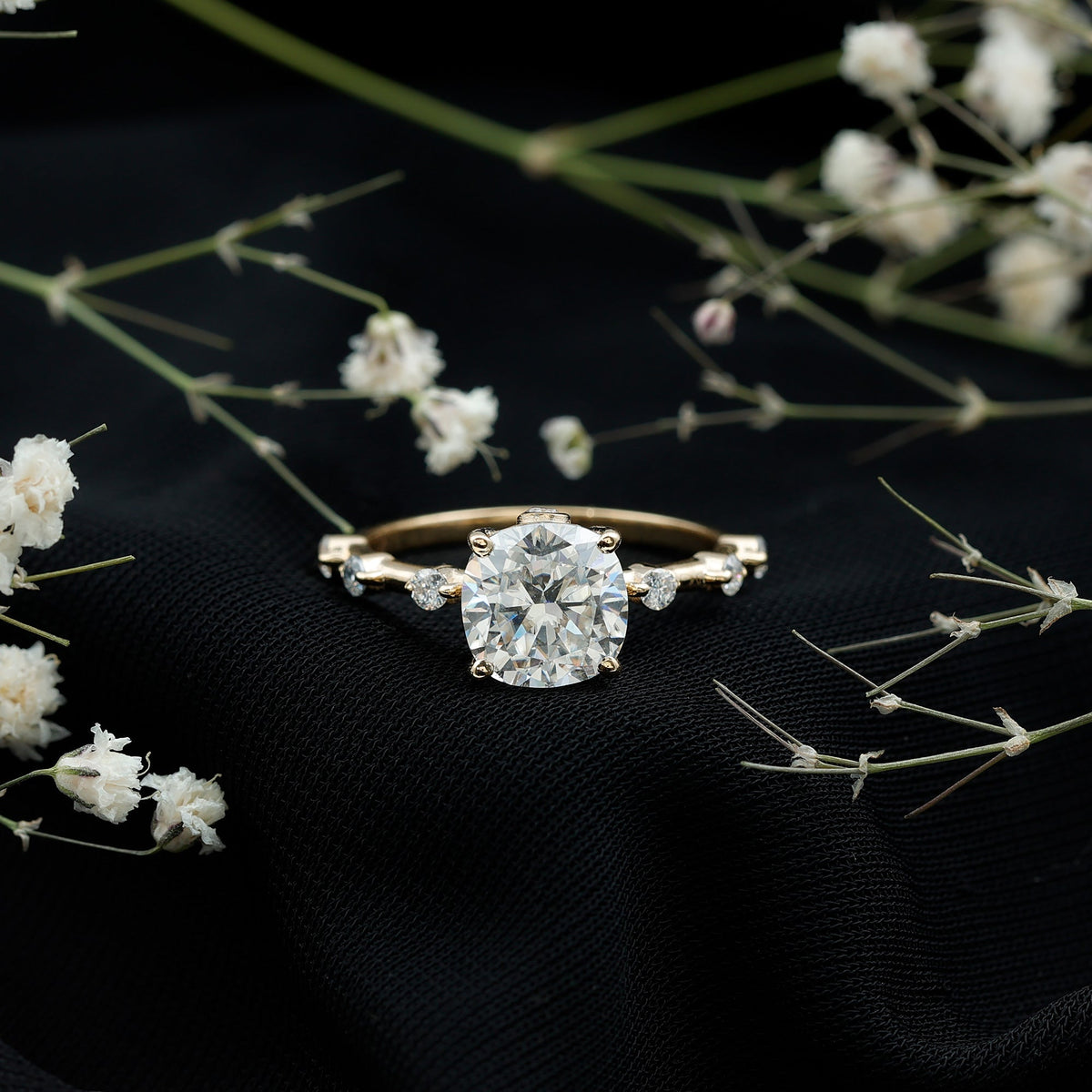 Yellow gold cushion-cut diamond solitaire ring with small side diamonds, prong setting