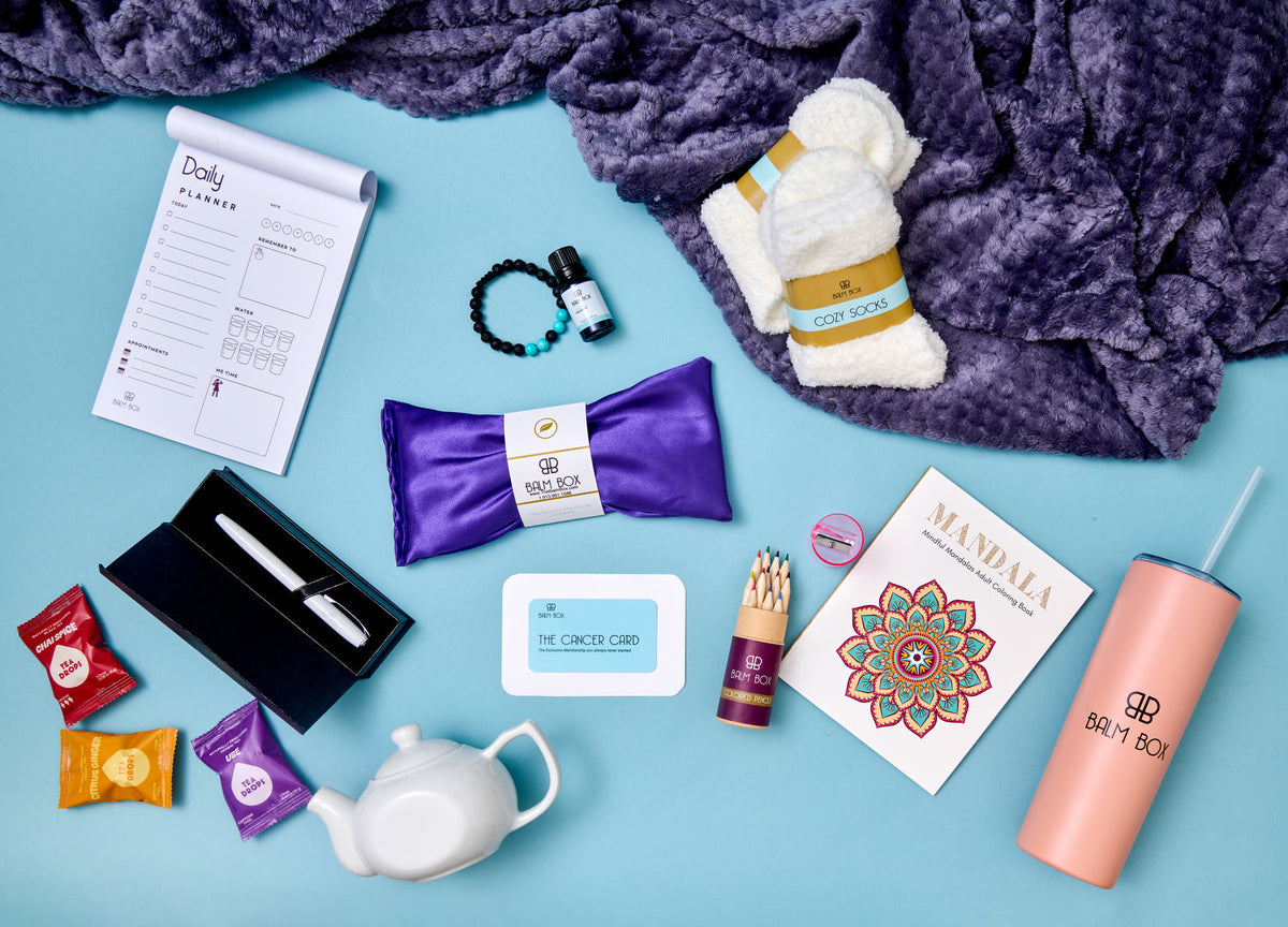 Recovery box contents with purple pouch, white socks, beaded bracelet, black box, tea infuser