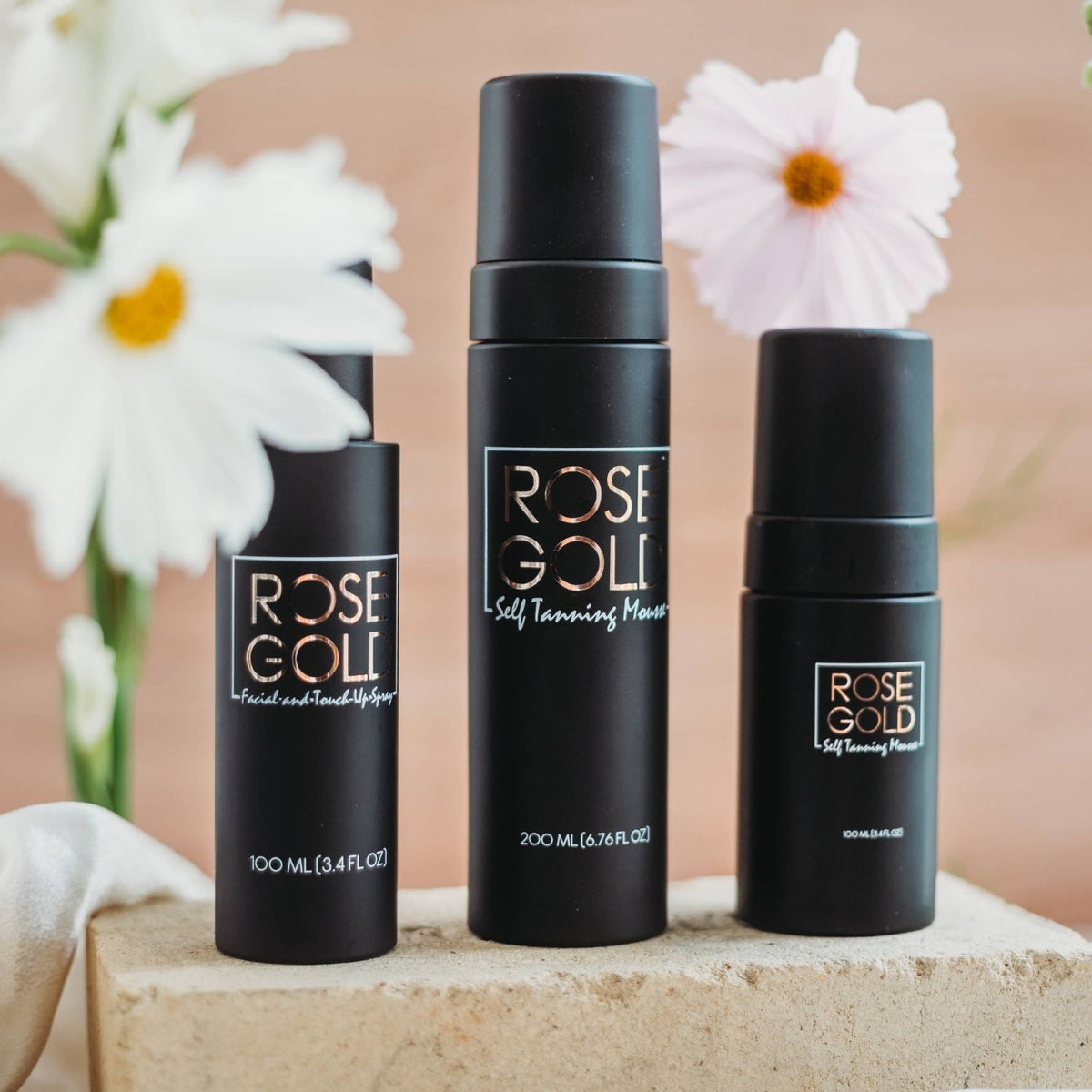 ROSE GOLD self-tanning mousse bottles in black containers with size labels