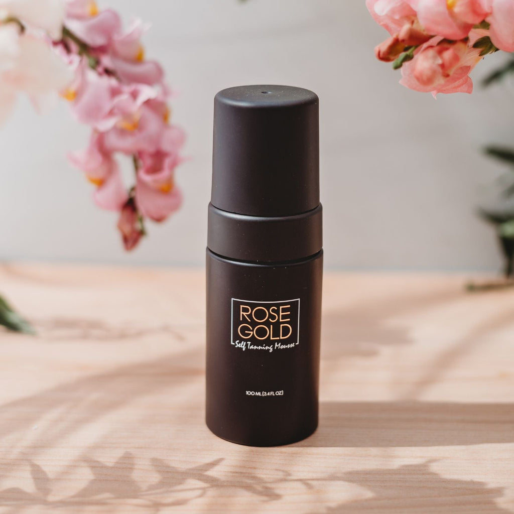 Travel-size self-tanning mousse bottle with black pump and Rose Gold label