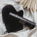 Self-tanning spray bottle with black applicator mitt, dark matte finish