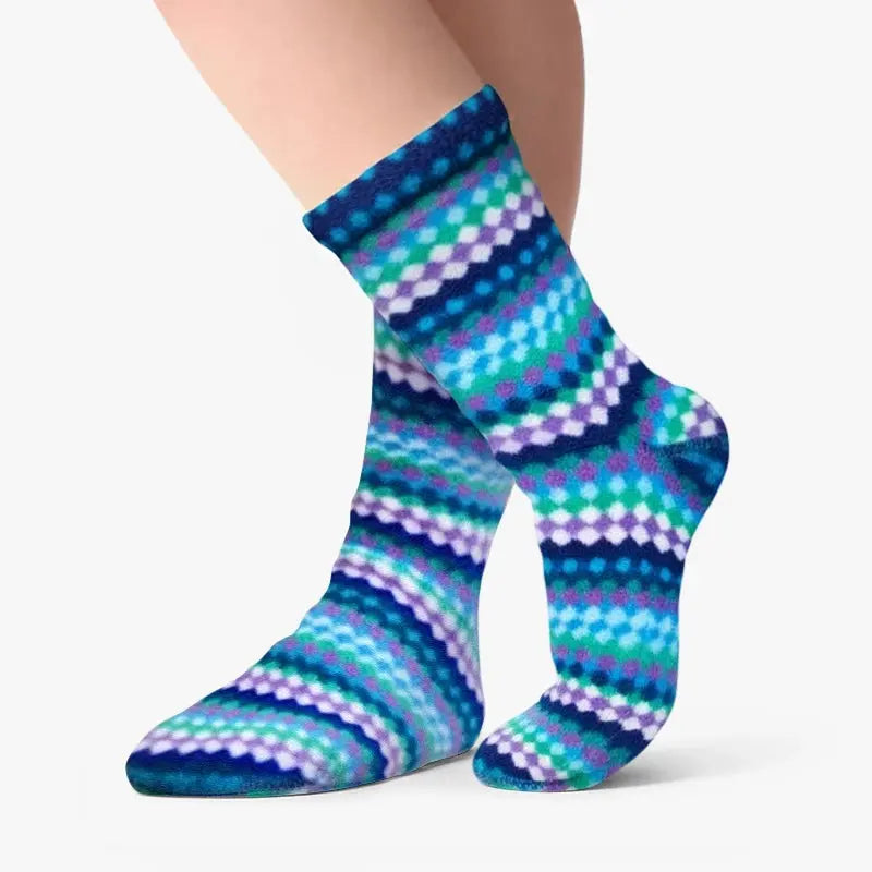 Kids' fleece socks, teal-and-purple ripple stripes, worn on child's legs.