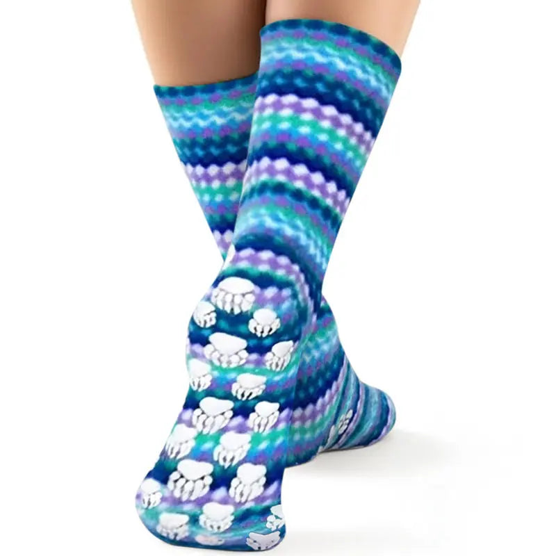 Fleece socks with ripple stripes and paw-print design on foot area, worn on legs.