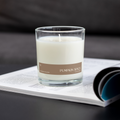 Pumpkin spice soy candle in clear glass jar with white wax and wick