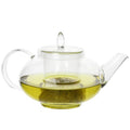 Borosilicate glass teapot with removable infuser, clear lid, handle, spout; green tea inside