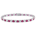 Tennis bracelet with round pink and clear stones in silver-tone prong settings