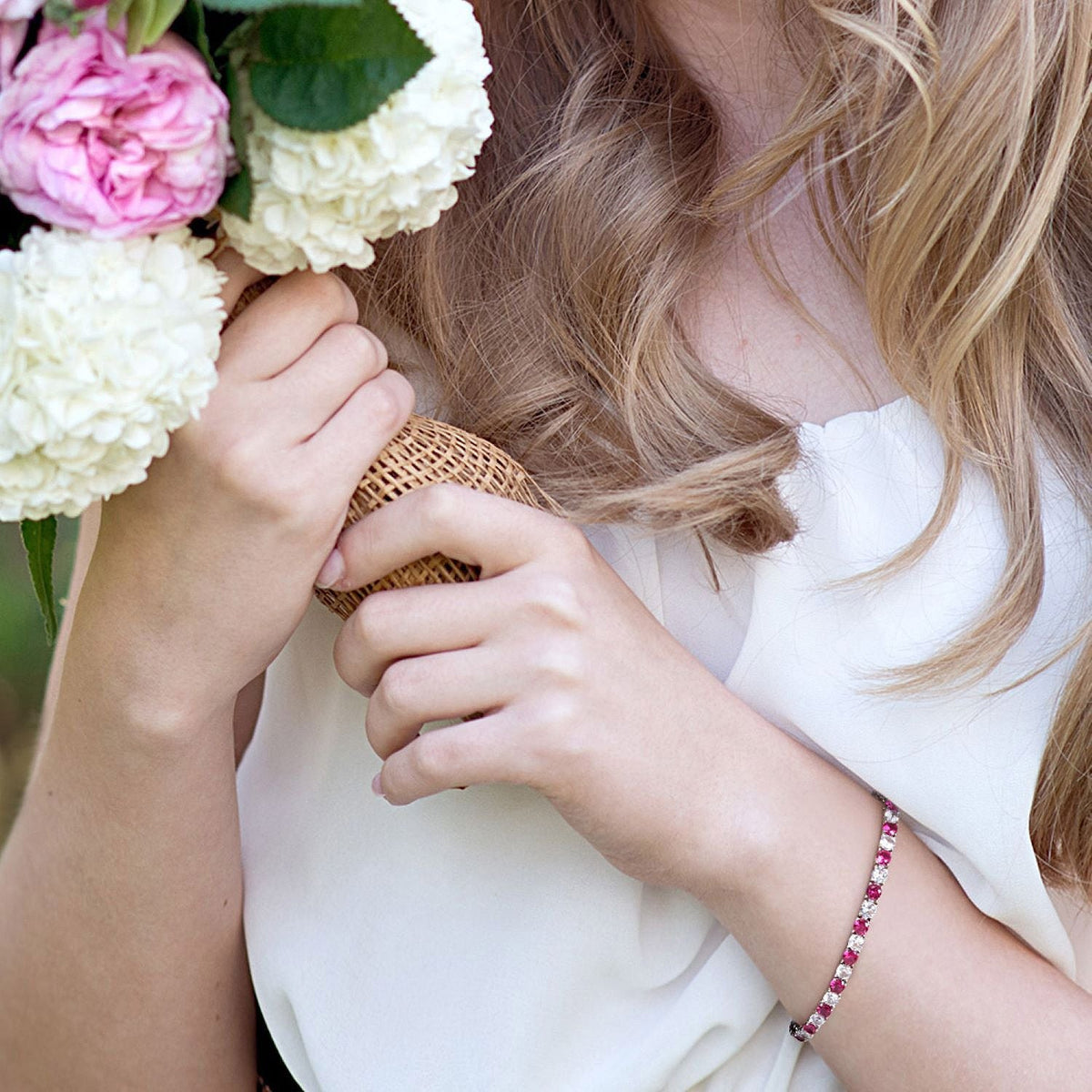 Pink and clear stone tennis bracelet on arm