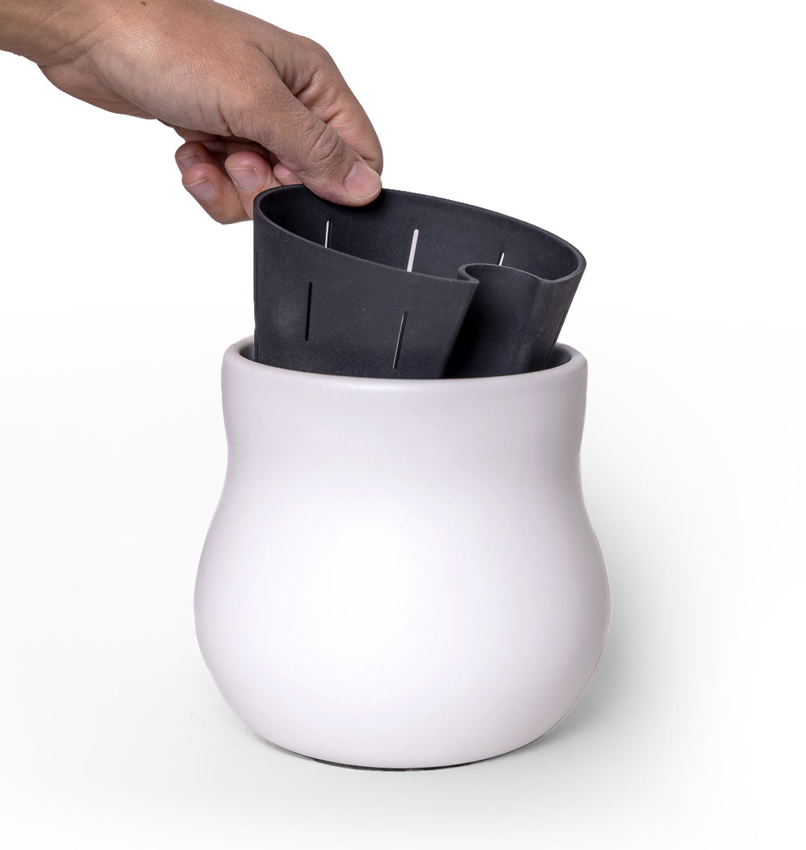 Alabaster white ceramic plant pot with black rubber liner, hand lifting insert