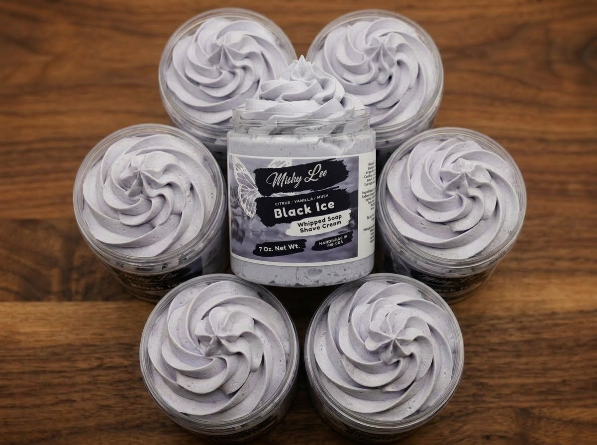 Set of small whipped soap tins with light purple rosette swirls on wooden surface