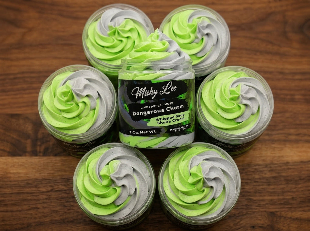 Set of small whipped soap tubs with green and gray swirl tops around main jar