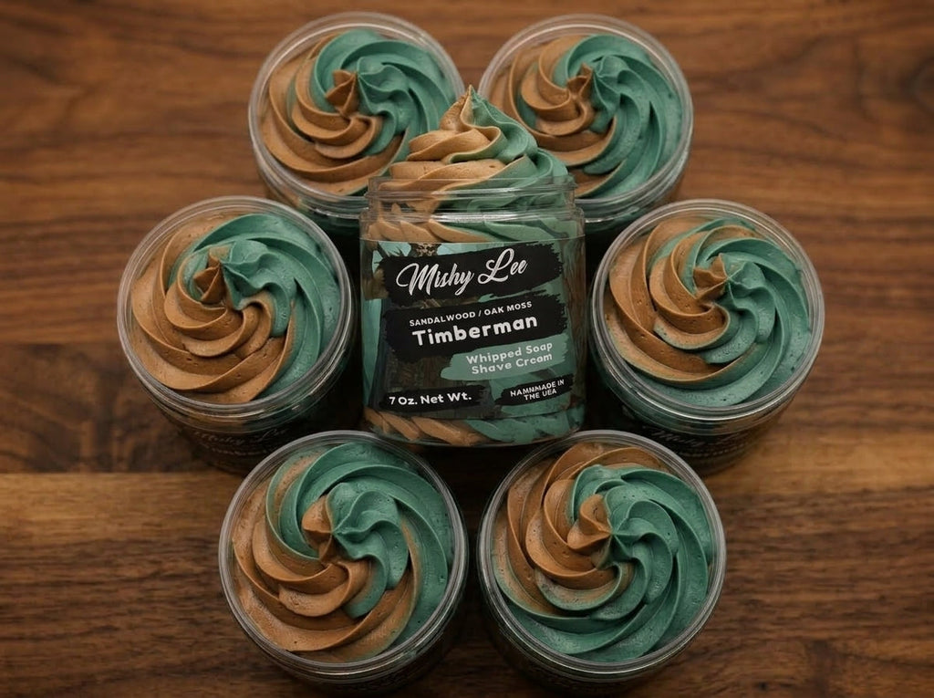 Multiple small jars of whipped soap and shave cream with teal and tan swirl tops