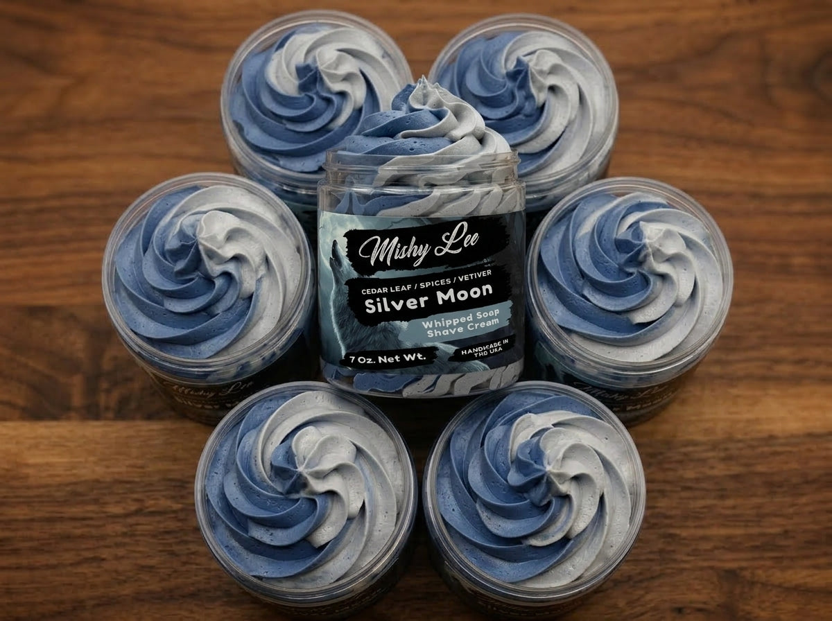 Multiple cups of blue whipped soap swirl around a Mushy Lee Silver Moon jar