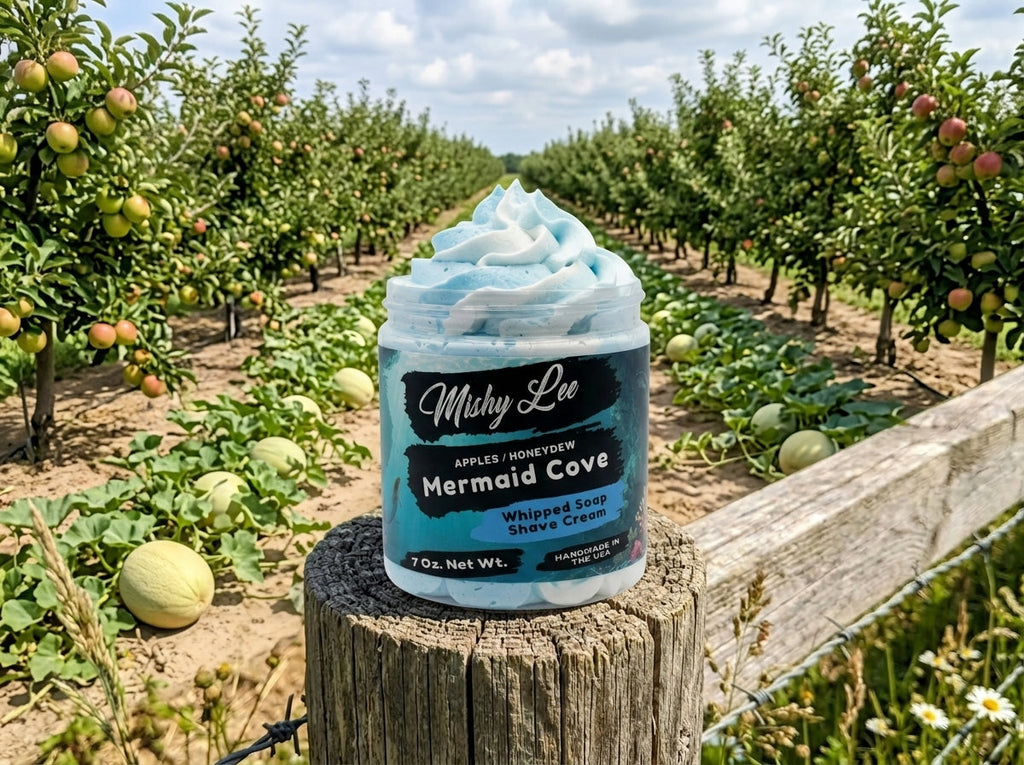 Light blue whipped soap and shave cream jar with swirled top outdoors.