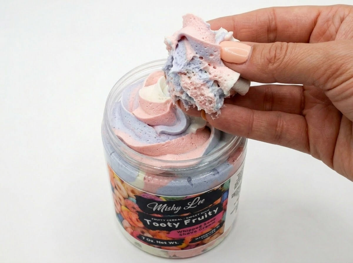 Hand scooping pastel whipped soap from the jar