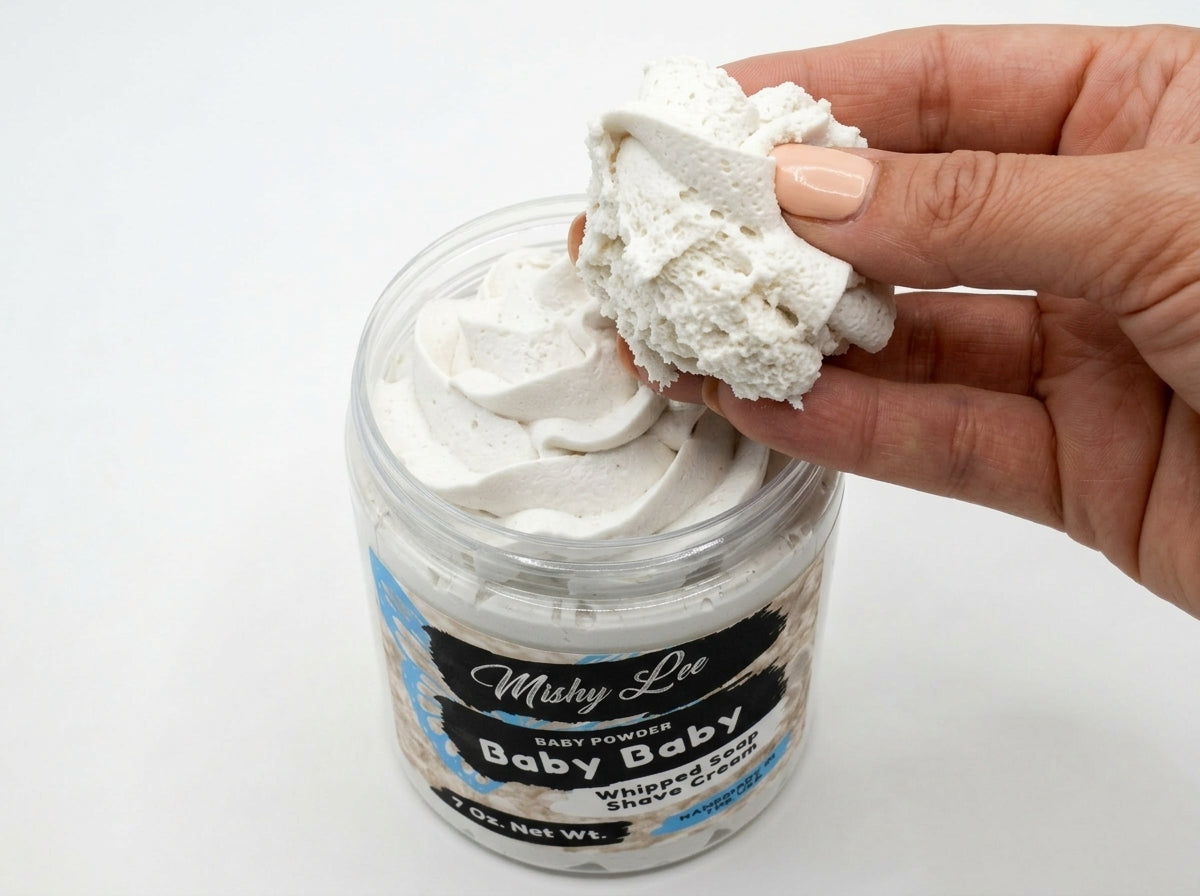 Baby whipped soap and shave cream jar with white whipped scoop in hand