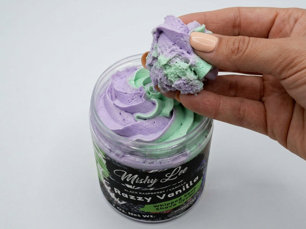 Hand holding purple and mint whipped soap scoop above jar, swirl texture