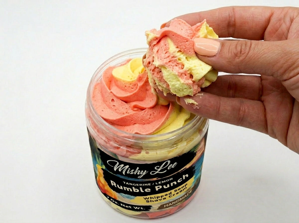 Whipped soap and shave cream scoop in hand, layered pink and yellow tangerine-lemon