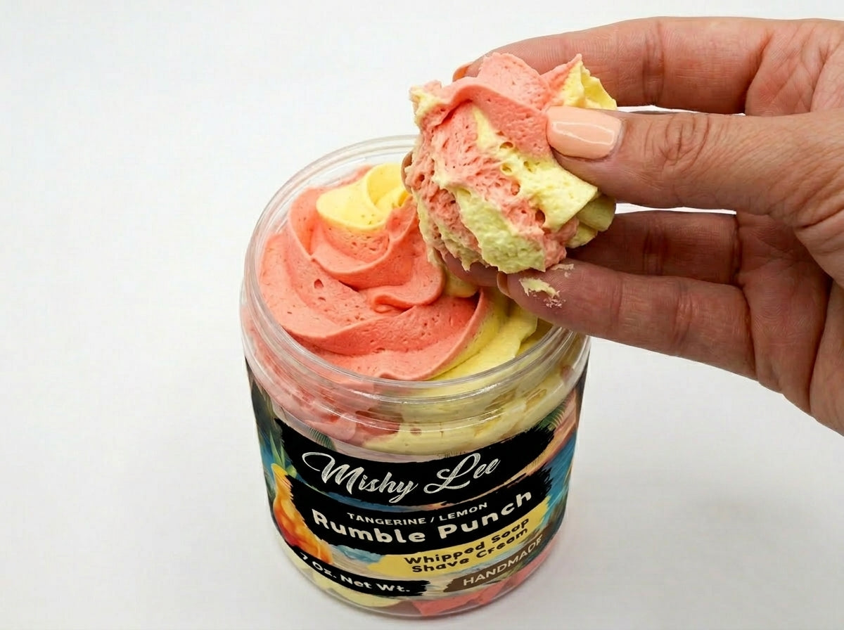 Whipped soap and shave cream scoop in hand, layered pink and yellow tangerine-lemon