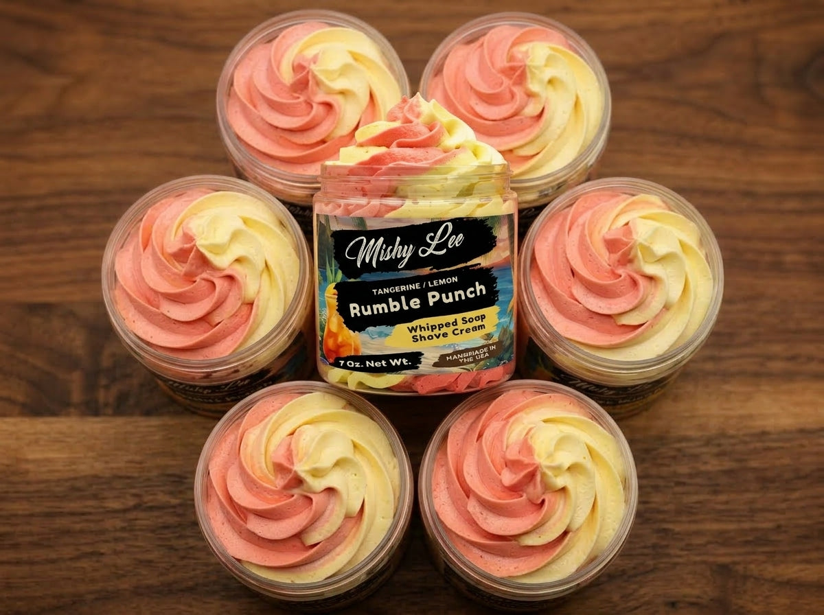 Assorted mini tins of whipped soap and shave cream with pink and yellow tangerine-lemon swirls