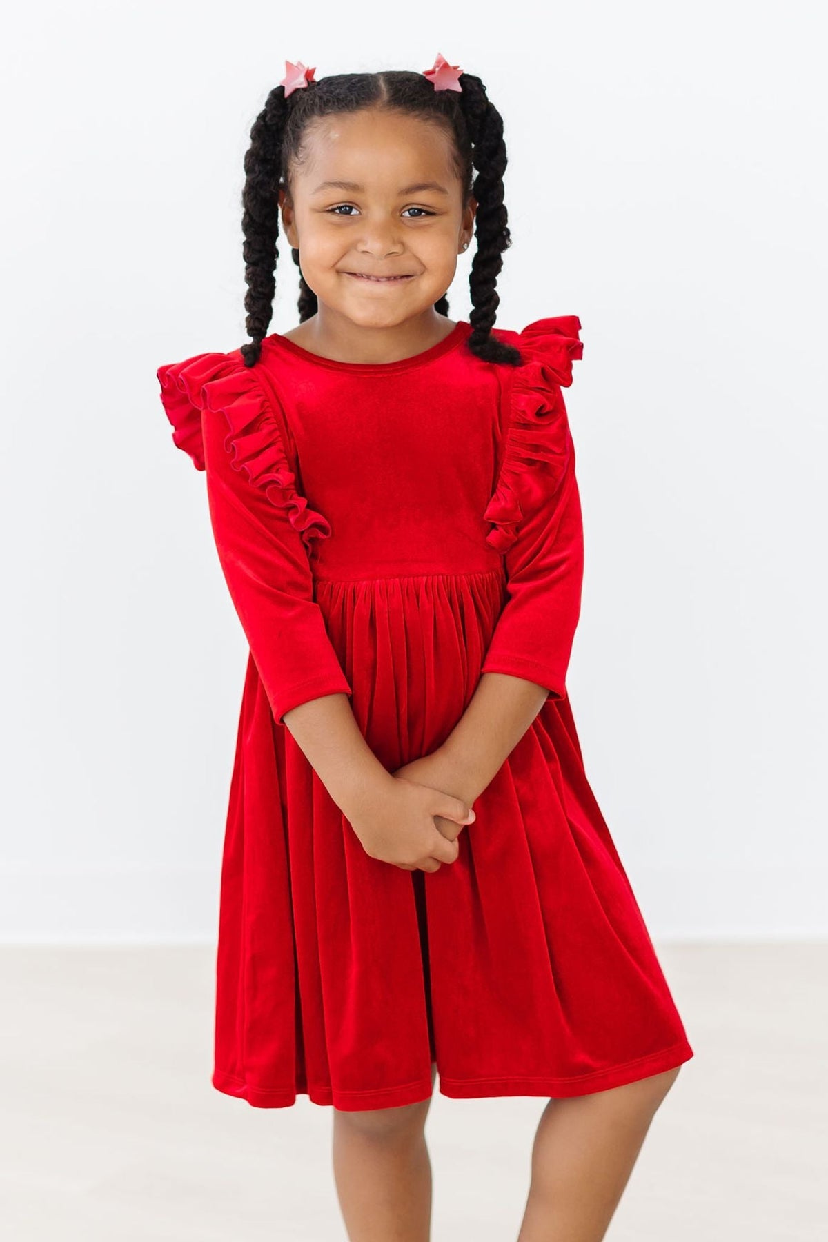 Red velvet ruffle dress with long sleeves, gathered waist, and flared skirt