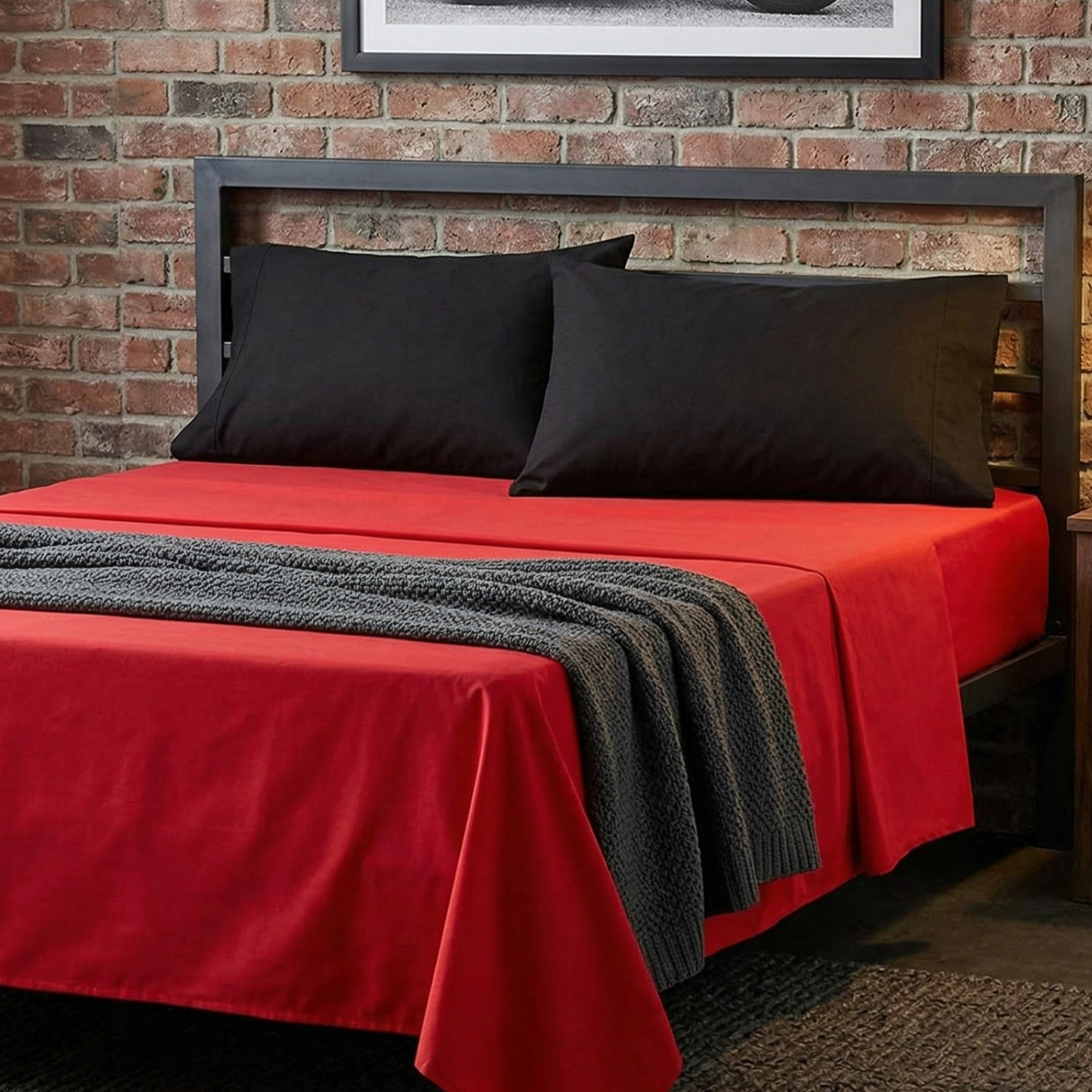 4-piece cotton sheet set with red flat sheet, black pillowcases, and dark accents
