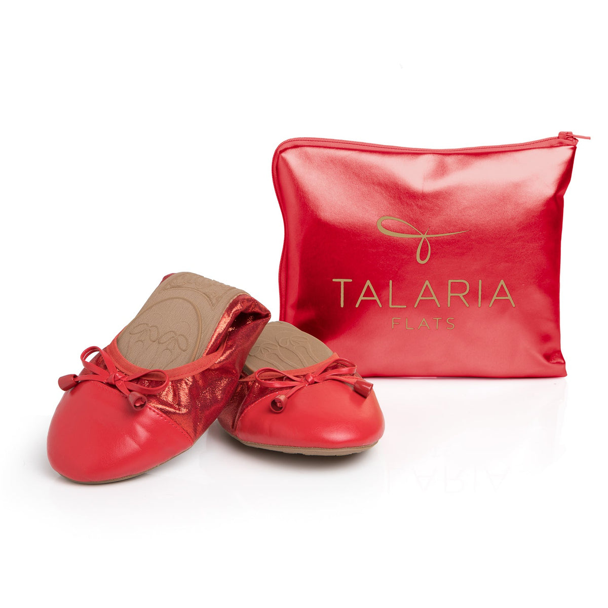 Ruby red metallic flats with matching red drawstring pouch, lace bows and rounded toe.